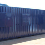 Exterior rear of converted container for motor sports including pedestrian door