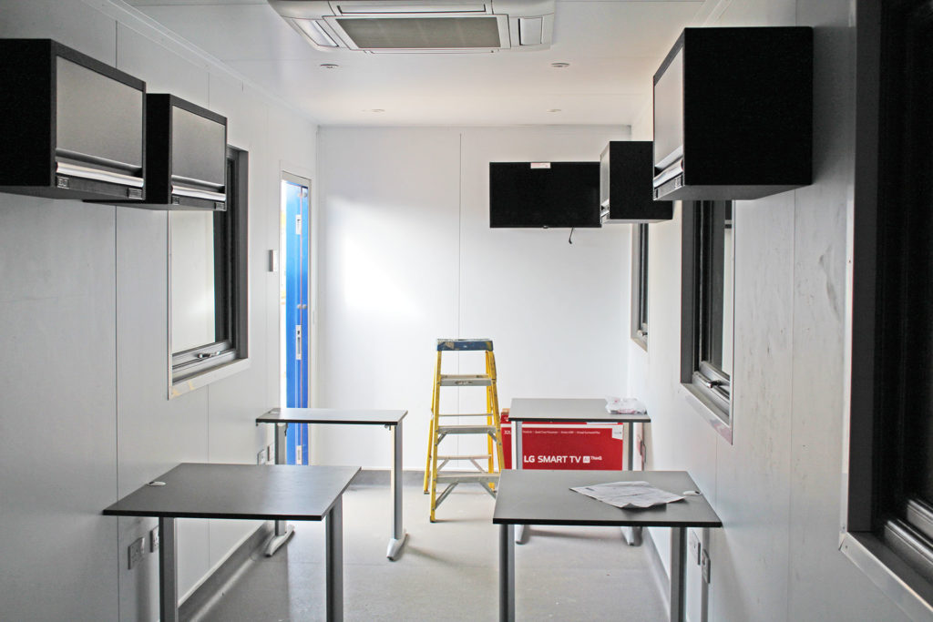Interior of container office with TV and aircon units