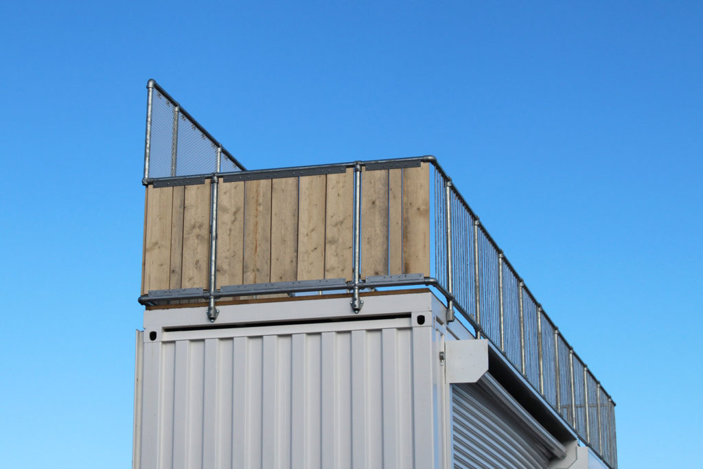 secure party area on top of converted container bar