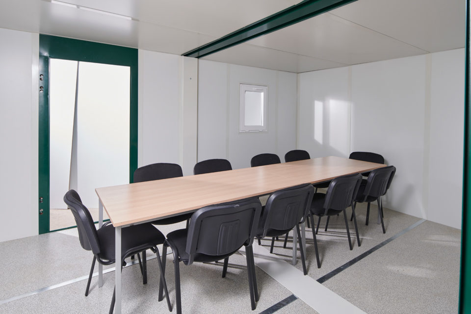 Conference room table within a linked flat pack office