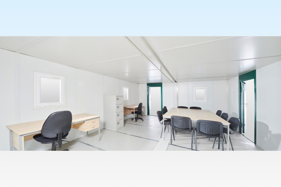 Interior of large flat pack cabin with office furniture